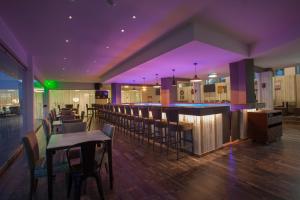 a restaurant with a bar and some tables and chairs at Princessa Vera Hotel Apartments in Paphos