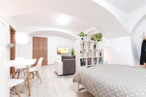 a bedroom with a bed and a table and a chair at The Maze Apartment in Ljubljana