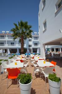 a group of tables and chairs and a building at Princessa Vera Hotel Apartments in Paphos