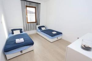 En eller flere senge i et værelse på Apartments Malkoc Lux