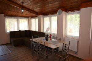 a living room with a table and a couch at Pálma Apartman in Gyula