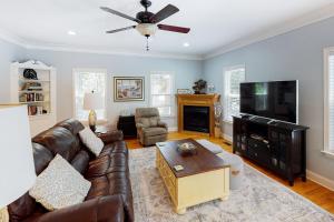 a living room with a couch and a flat screen tv at Chateau Relaxo in Edisto Beach