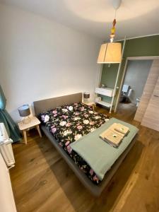 a bedroom with a bed with a blanket on it at AFFITTACAMERE DA ANDRE E MARY in Venzone