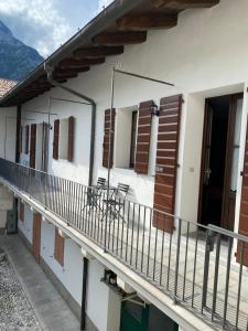 a balcony of a house with chairs on it at AFFITTACAMERE DA ANDRE E MARY in Venzone