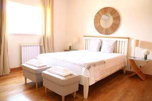 a bedroom with a white bed with a mirror on the wall at Quinta da Chapeleira em Azeitão in Azeitao +46 photos