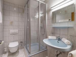a bathroom with a shower and a sink and a toilet at Haus Elsa in Brixen im Thale +17 photos