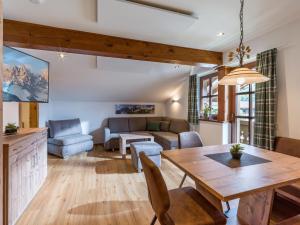 a living room with a table and a couch at Haus Elsa in Brixen im Thale