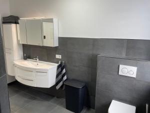 a bathroom with a sink and a mirror at Sauerland Apartment Deluxe in Olpe