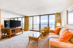 a living room with a couch and a flat screen tv at Kaanapali Shores 706 in Kaanapali