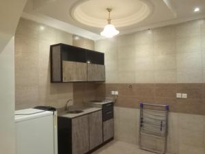 a kitchen with a sink and a refrigerator at Ebreeze Al Hijaz - Previously Amarena in Jeddah