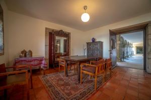 a dining room with a wooden table and chairs at Convento San Payo in Vila Nova de Cerveira
