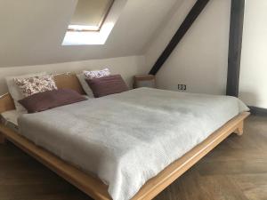 a bedroom with a large bed in a attic at Apartament Ernesta in Krapkowice