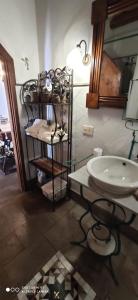 a bathroom with a white sink and a mirror at L'AGRUMETO SEGRETO in Riola Sardo
