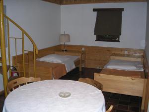 ポストイナにあるCamping Pivka Jama Postojnaのベッド2台、テーブル、窓が備わる客室です。