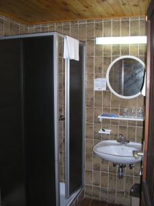 a bathroom with a sink and a mirror at Camping Pivka Jama Postojna in Postojna