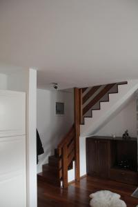 a living room with a staircase with wooden floors at Apartment MT Čezsoča in Bovec
