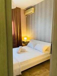 a bedroom with a bed with two towels on it at Kapsalakis Penthouse in Korinthos