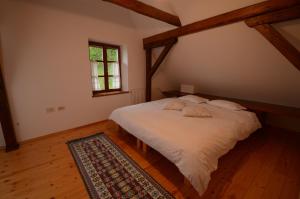 a bedroom with a white bed in a attic at Holiday Home Natura in Bovec