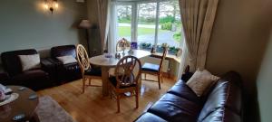 a living room with a couch and a table at Colmán House in Kilmihil