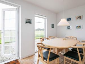 a dining room with a wooden table and chairs at 6 person holiday home in Brenderup Fyn in Bro