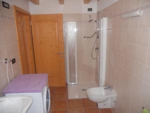 a bathroom with a shower and a toilet and a sink at Agritur Melango in Fondo