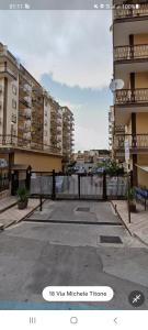 uma cerca branca em frente a alguns edifícios altos em Alberira Apartments em Palermo