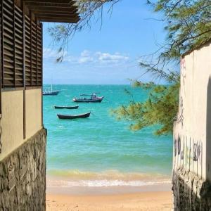 two boats in the water on a beach at Casa de Praia in Búzios