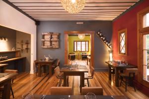 a restaurant with wooden tables and chairs and a chandelier at Esencia Hotel Boutique in Viña del Mar