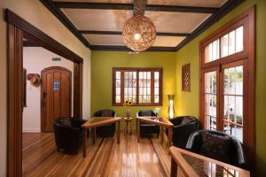 a living room with chairs and a table and a chandelier at Esencia Hotel Boutique in Viña del Mar