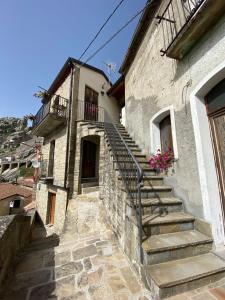 a stone building with stairs on the side of it at La Pietra Gialla in Pietrapertosa