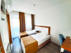 A bed or beds in a room at Karden Otel Még 37 kép