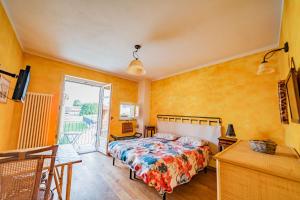 a bedroom with a bed and a sliding glass door at Arzigà in Chieri