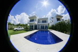 a house with a swimming pool in front of it at VILLA MANDALAY in Santa Verónica