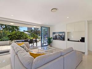 a living room with a couch and a table at Nielsen on the Park Unit 1 3 Bed in Coolangatta
