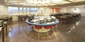 a restaurant with tables and chairs and a large room at Nest Hotel Kumamoto in Kumamoto