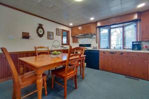 a kitchen with a wooden dining room table and chairs at Huge historic, w/large yard & close to beach in Manistee