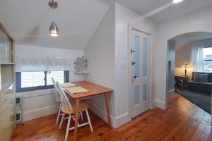 a kitchen and dining room with a table and chairs at Historic w/deck, king bed & air by Lake Michigan in Manistee
