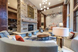 a living room with a couch and a fireplace at Luxury Amenities and Resort Ski In Ski Out Pool Hyatt 1 Bedroom in Park City