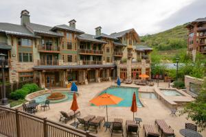 a resort with a swimming pool with chairs and umbrellas at Luxury Amenities and Resort Ski In Ski Out Pool Hyatt Double Queen Hotel Room in Park City