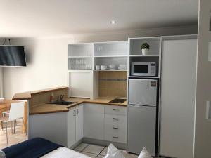 A kitchen or kitchenette at At The Sound Noosa Motel