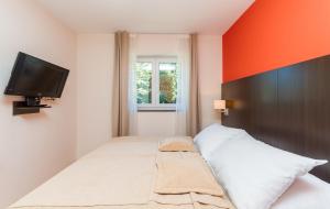 a bedroom with a bed and a flat screen tv at Apartment Residence Marina Portorož LEBIČ 411 in Portorož +16 photos