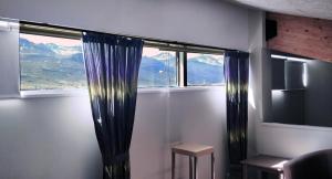 a room with a window with a view of mountains at SAXA Guesthouse in Stöðvarfjörður