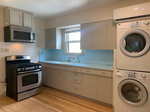 a kitchen with a stove and a washer and dryer at 125-#4 Downtown cozy upstairs one bedroom apt in San Antonio