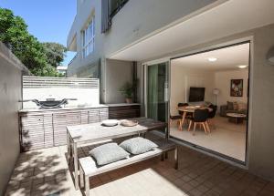a balcony with a table and a dining room at Portofino 2 in Noosa Heads
