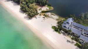 an overhead view of a beach with a building and the water at Cassia Residences by Laguna Phuket in Bang Tao Beach