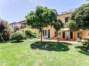 a garden with a swing in front of a house at Belvilla by OYO Villa Lazzarino in Pisa