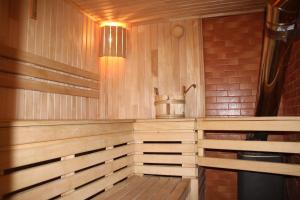 a wooden sauna with a bucket on the wall at Sofia in Yaremche
