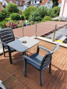 a table and two chairs sitting on a deck at T&K Appartements in Bad Homburg vor der Höhe