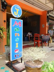 a sign for a restaurant in front of a building at J Apartment in Ao Nang Beach