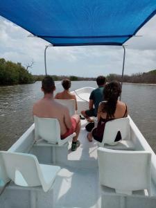 a group of people sitting on a boat on the water at Casa Ka'an Rio. in Río Lagartos
